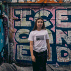 Person wearing a t-shirt with an upside-down American flag design that says America is Revolting