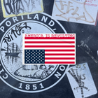 Upside down American flag sticker with 'America is Revolving' text on a textured background