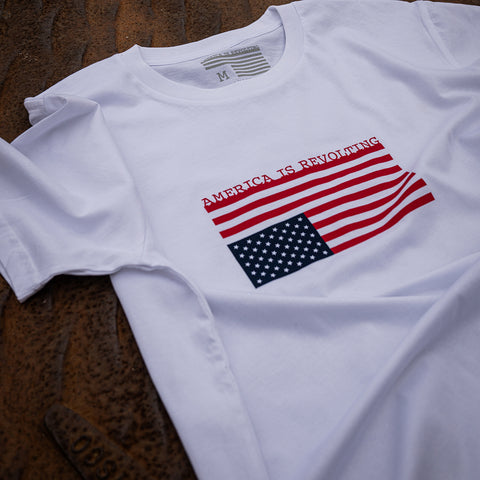 White t-shirt with an upside-down American flag design that says America is Revolting