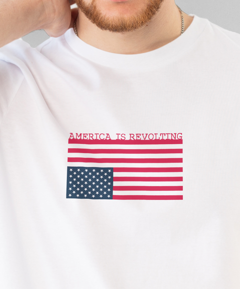 White t-shirt with an upside down American flag and 'America is Revolting' graphic above the flag